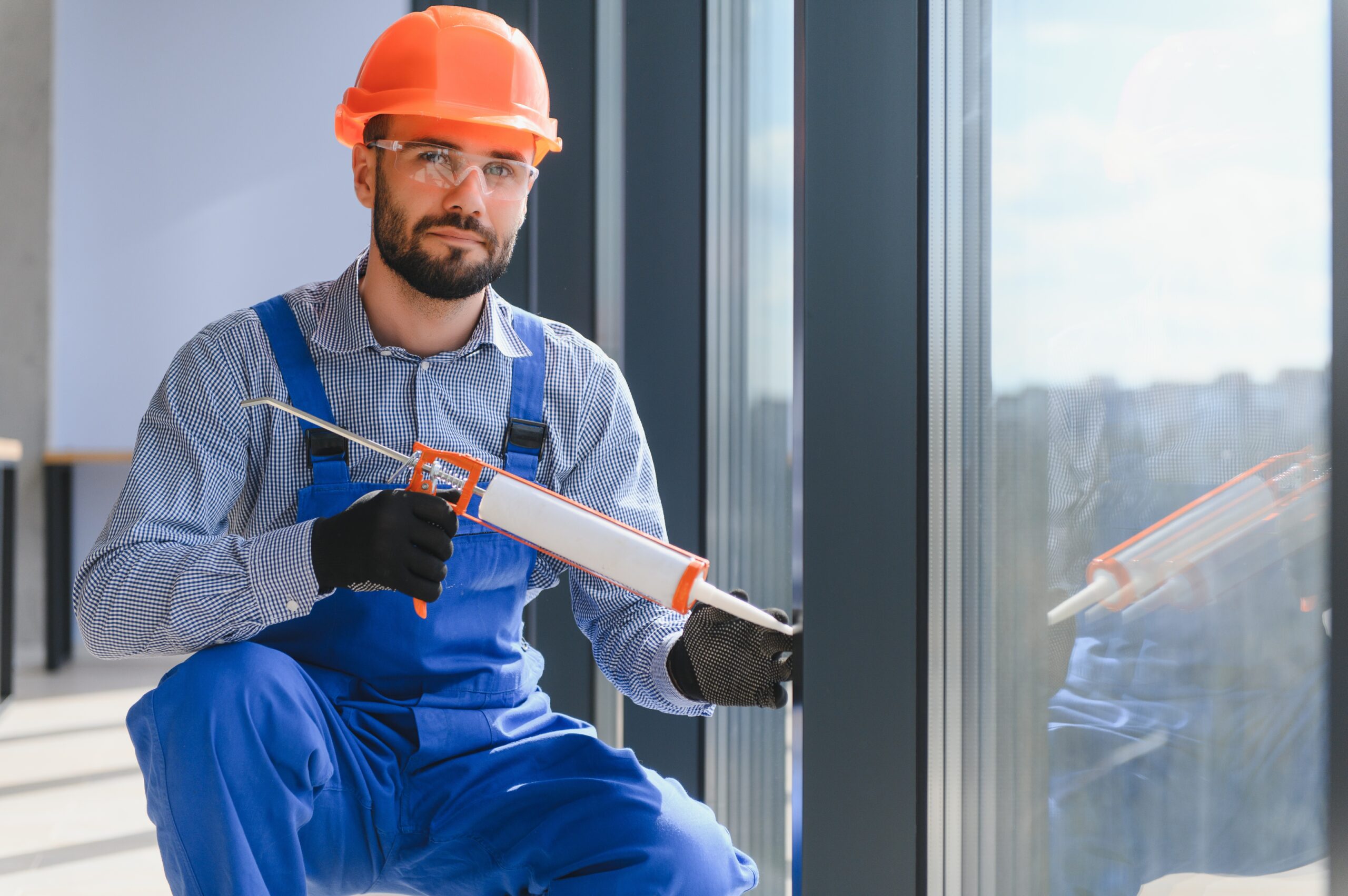 Man caulking window