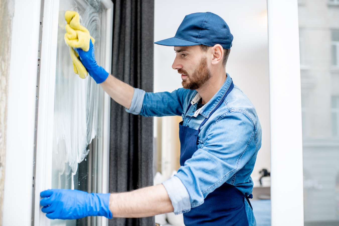 professional window cleaner wiping a window
